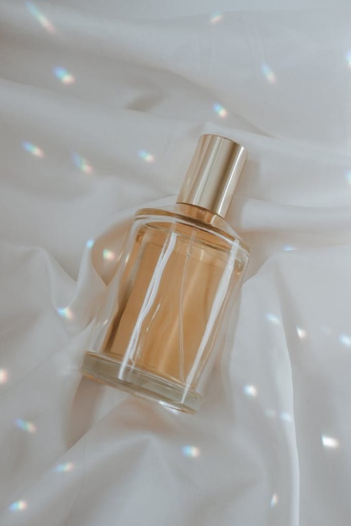 A luxurious perfume bottle elegantly displayed on soft satin fabric with soft light reflections.